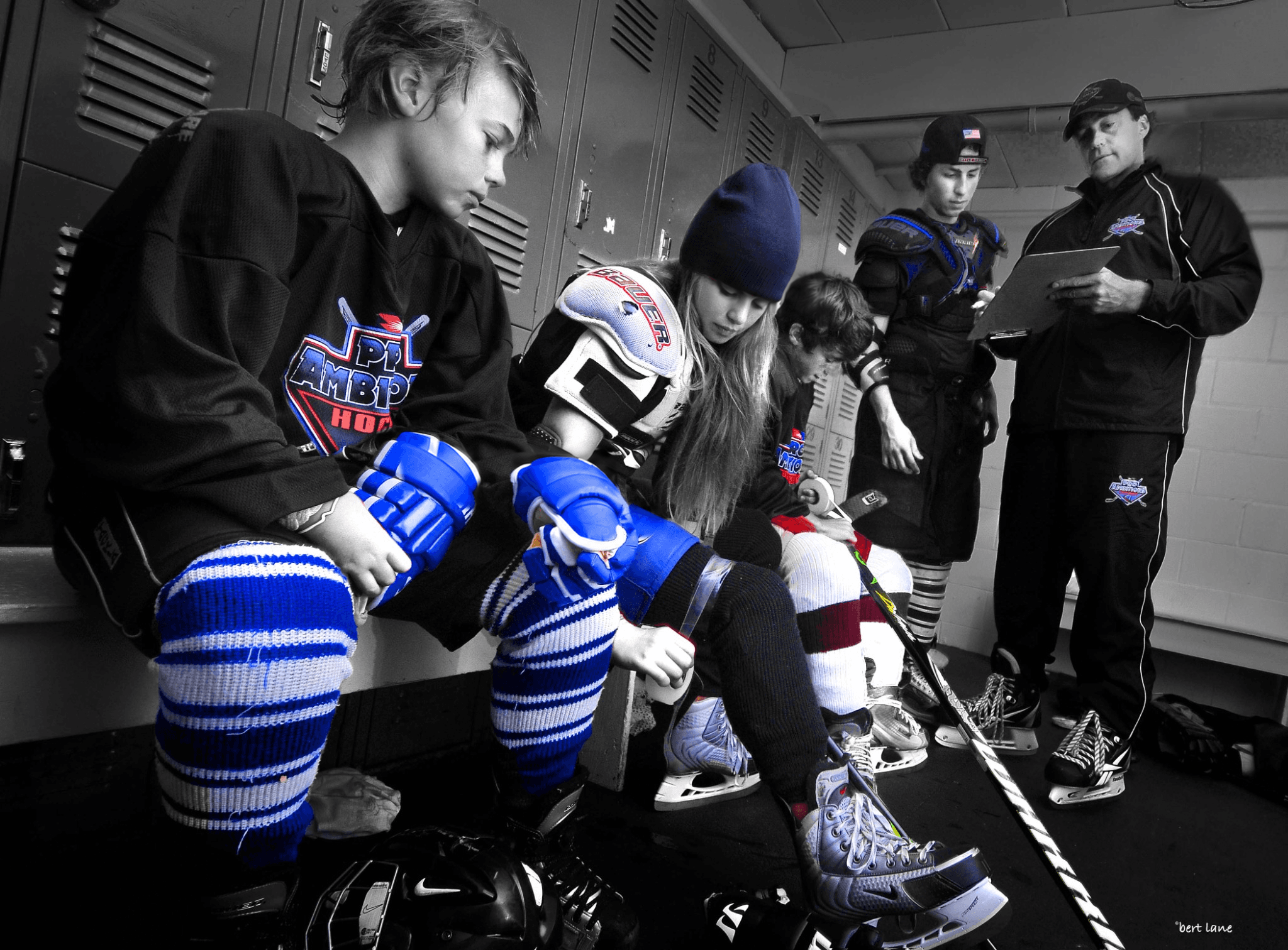 Pro Ambitions Hockey campers gearing up in the locker room with coach Jeff Serowik